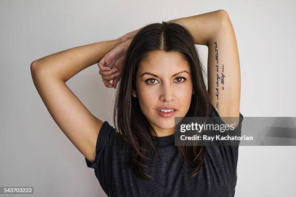 woman with tattoo arms over head portrait - ミディアムヘア ストックフォトと画像