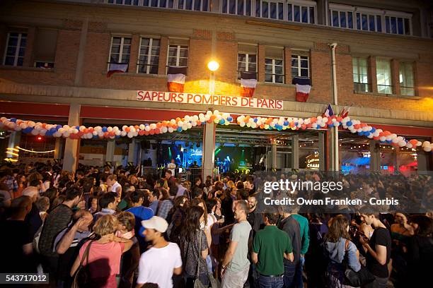 People are gathering to a fire station in Paris to attend the traditionnal firemen ball, as part of a celebration of the Bastille Day