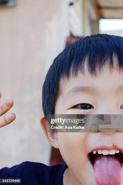 A Japanese Boy Sticking Out His Tongue High-Res Stock Photo