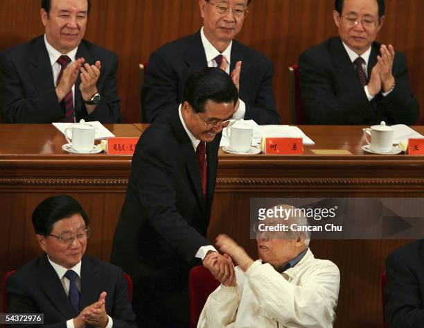 Chinese President Hu Jintao shakes hands with a war veteran during a meeting marking the 60th anniversary of the victory of China's Resistance War...