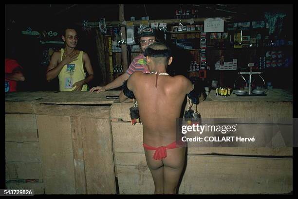 Yanomami getting his first contact with 'white men' in the illicit gold mine's gambling den. This is where the decline of the Yanomamis starts.