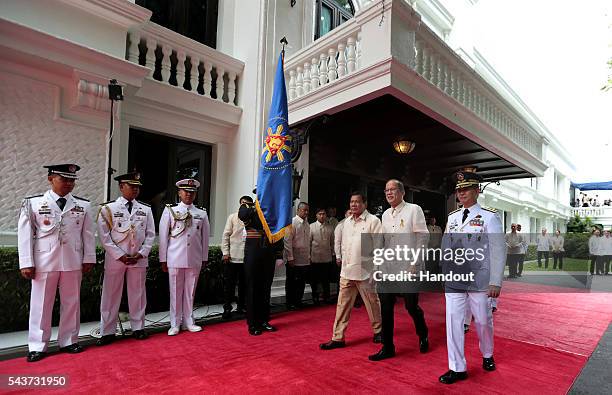 In this handout image provided by Malacanang Photo Bureau, Outgoing President Benigno S. Aquino III reviews the honor guards during the Departure...