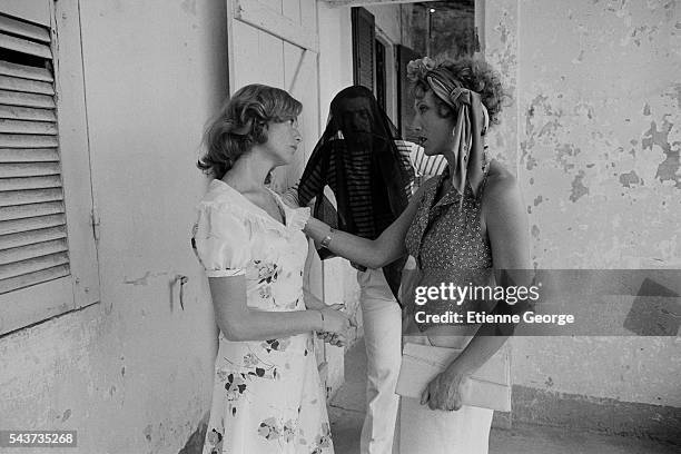 French actress Isabelle Huppert, Eddy Mitchell and Stephane Audran on the set of Coup de Torchon written and directed by Bertrand Tavernier. |...