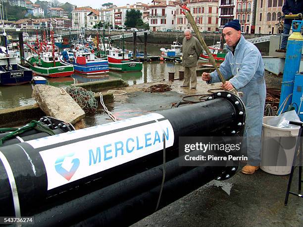 The crew of the boat "L'ile aux Faisans" prepares the frames of the new pollution-reducing nets that are part of the device used to fight against a...