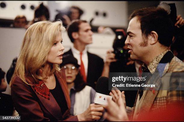 Actress Kim Basinger and French fashion designer Christian Lacroix on the set of the film Prêt-à-Porter, , directed by American director Robert...