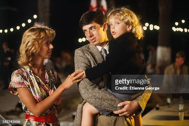 French actress Fiona Gélin and French actor and singer Patrick Bruel holding Alexandre Arcady's son Alexandre Aja, future French director on the set...
