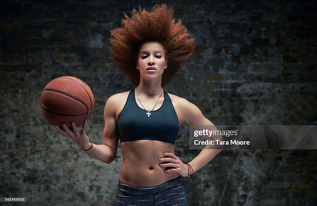 Female athlete with basketball brick background