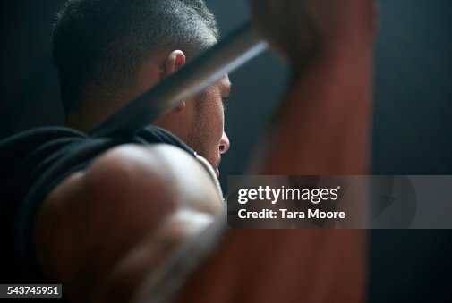 Male athlete lifting weight bar black background Male athlete lifting weight bar black background