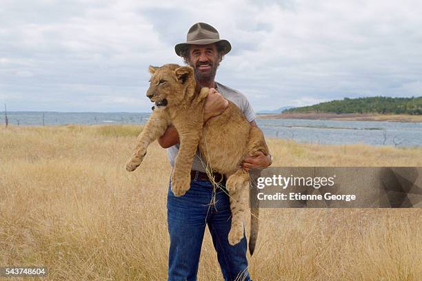 French actor Jean-Paul Belmondo with a lion cub on the set of "Itineraire d'un enfant gate", directed by Claude Lelouch. Belmondo won the 1989 Cesar...