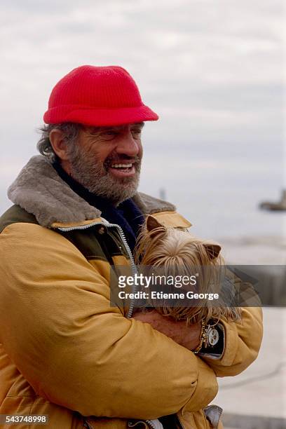 Actor Jean-Paul Belmondo and his pet dog on the set of "Itineraire d'un enfant gate" , directed by Claude Lelouch. Belmondo won the 1989 Cesar award...