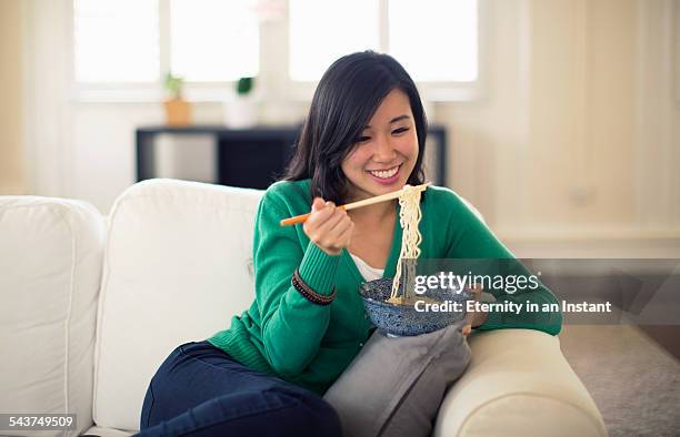 young woman eating noodles - noodles eating stock pictures, royalty-free photos & images