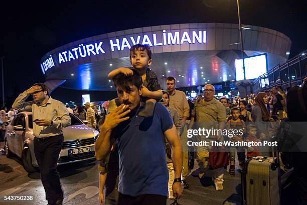 Scenes of police and passengers leaving Ataturk International Airport hours after three suspected bombs went off near the main entrance to the...