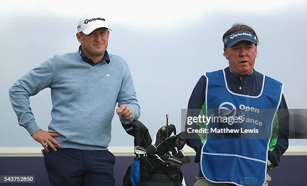 Jamie Donaldson of Wales looks on with his caddie Michael 'Mick' Donaghy during day one of the 100th Open de France at Le Golf National on June 30,...