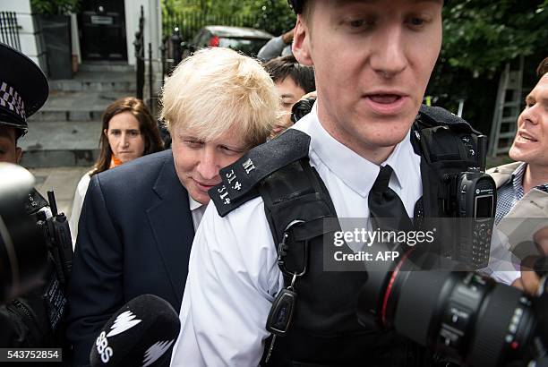 Former London Mayor, Boris Johnson, is escorted by police personnel as he leaves his home in London on June 30, 2016. Brexit campaigner Michael Gove...