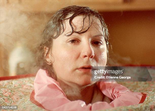 French actress Josiane Balasko in a steam box on the set of the film "Les Hommes Preferent les Grosses" , directed by French director Jean-Marie...