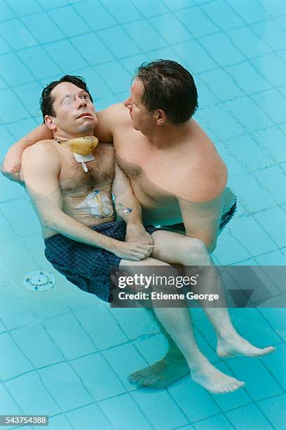 French actor Mathieu Amalric with a physiotherapist on the set of the film "Le Scaphandre et le Papillon" , directed by American artist, painter and...