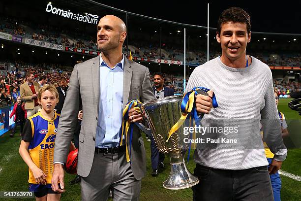 Chris Judd and Andrew Embley walk a lap of honour with team mates celebrating the West Coast Eagles 2006 Premiership anniversary during the round 15...