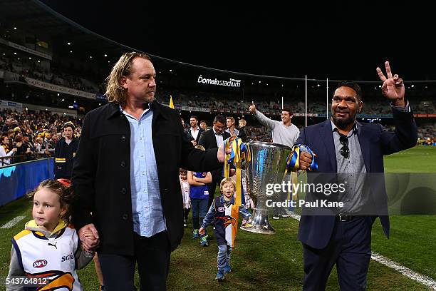 Daniel Chick and David Wirrpanda walk a lap of honour with team mates celebrating the West Coast Eagles 2006 Premiership anniversary during the round...