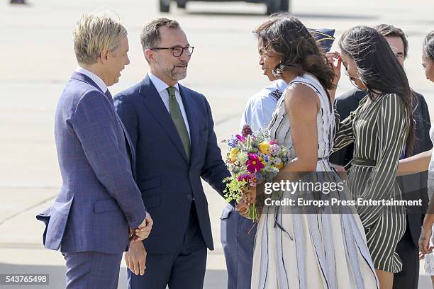 First Lady Michelle Obama receives flowers with her daughter Malia Obama at Torrejon Air Force Base by US ambassador James Costos and Michael Smith...