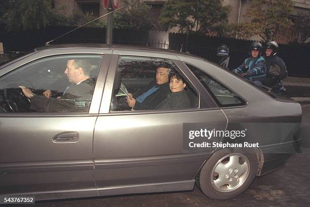 Dominique Strauss Kahn and his wife Anne Sinclair leave their home.