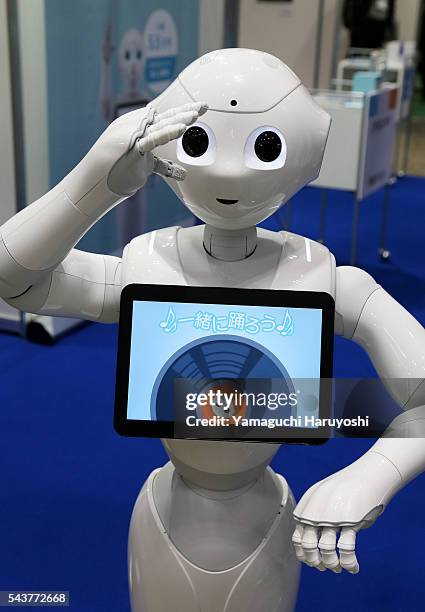 Pepper, a humanoid robot designed to live with humans, talks to visitors during the International Robot Exhibition started in Tokyo on Wednesday,...