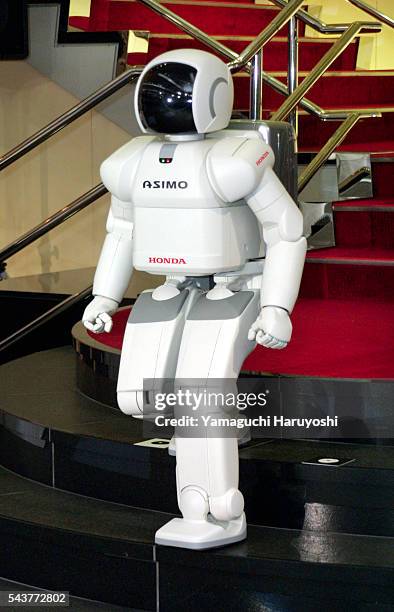 Honda Motor Corp's humanoid robot "ASIMO" walks down the stairs during a press preview in Tokyo. Honda Motor introduced a new, improved version of...