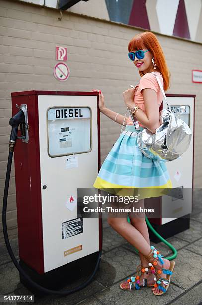 Sussan Zeck is wearing a jacket by Christian Pellizzari, a skirt bei HOPPER, a bag and bracelet by Marc Cain and shoes by Moda Espana during the...