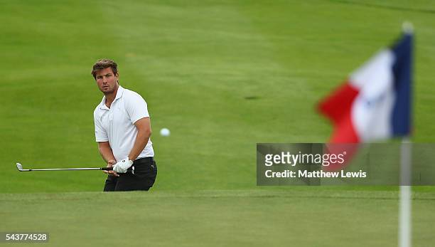 Mathieu Decottignies-Lafon of France chips onto the 12th green during day one of the 100th Open de France at Le Golf National on June 30, 2016 in...
