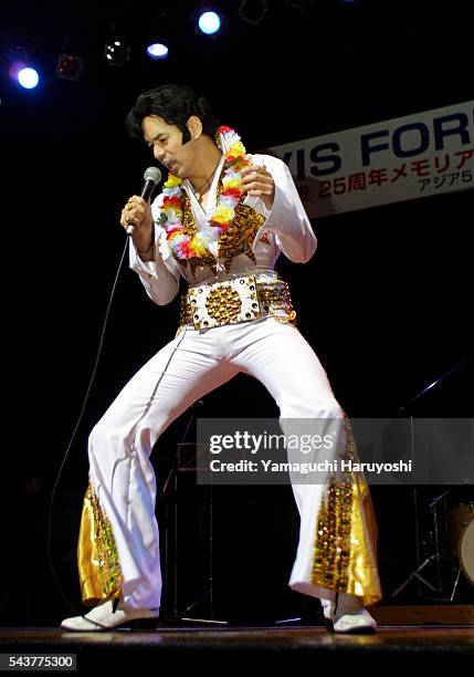 Elvis Presley impersonator, Vasu Sangsingkeo of Thailand, performs a Presley tune at an "Elvis Forever" concert at the Kudan Kaikan Auditorium....