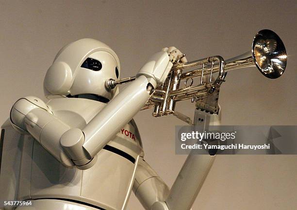Toyota Motor Corporation's new "Toyota Partner Robot" plays a trumpet during a news conference. The newly-developed robot stands 120 centimeters tall...