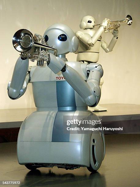 The Toyota Motor Corporation's new "Toyota Partner Robots" play trumpets during a news conference. The newly-developed robot stands 120 centimeters...