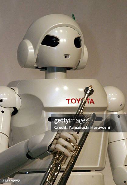 Toyota Motor Corporation's new robot "Toyota Partner Robot" holds a trumpet during a news conference. The newly-developed robot stands 120...