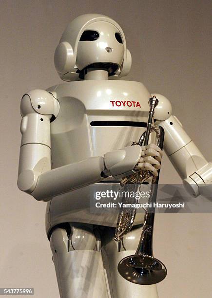 Toyota Motor Corporation's new "Toyota Partner Robot" holds a trumpet during a news conference. The newly-developed robot stands 120 centimeters tall...