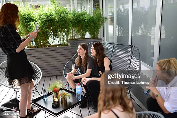 Eliot Paulina Sumner and Lucie Von Alten are being photographed by a guest during the Mercedes-Benz Fashion Week Berlin Spring/Summer 2017 at Erika...