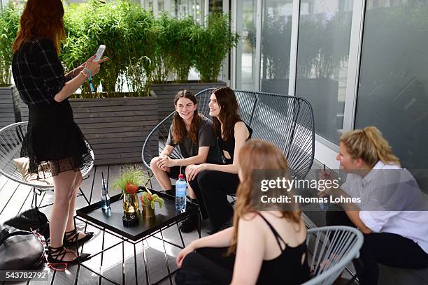 Eliot Paulina Sumner and Lucie Von Alten are being photographed by a guest during the Mercedes-Benz Fashion Week Berlin Spring/Summer 2017 at Erika...