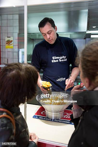 Brussels, Belgium, April 10; 2013. -- Eric DUHAMEL, the owner of the Fritkot Bompa prepres fries "La frites suspendu" for clients. The idea was born...