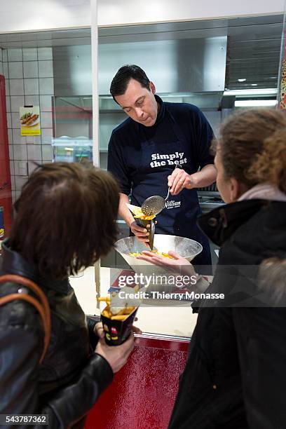 Brussels, Belgium, April 10; 2013. -- Eric DUHAMEL, the owner of the Fritkot Bompa prepres fries "La frites suspendu" for clients. The idea was born...