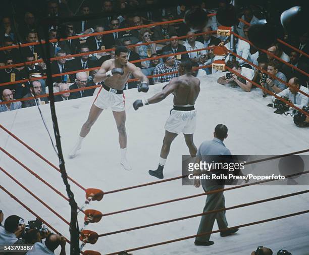American boxers Cassius Clay and Sonny Liston pictured together in a World Heavyweight title fight at the Convention Hall in Miami Beach, Florida on...