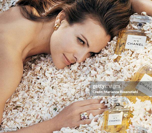 French actress Carole Bouquet, the face of Chanel No. 5 perfume, poses in a field of jasmine.