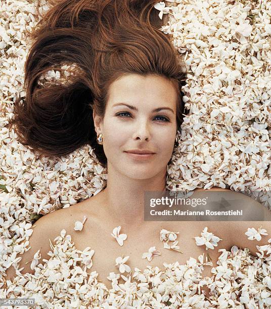 French actress Carole Bouquet, the face of Chanel No. 5 perfume, poses in a field of jasmine.