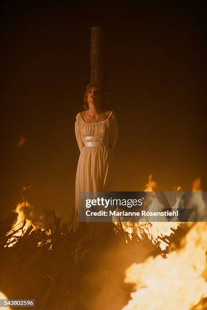 French singer Mylène Farmer is tied to a stake and surrounded by flames on the set of her music video Beyond My Control directed by French composer...