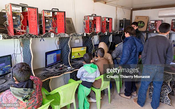 Za'atari, Mafraq Governorate, Jordan, February 5; 2014. -- Childs enjoy computer games in the cyber cafe of the camp. Zaatari is a refugee camp in...