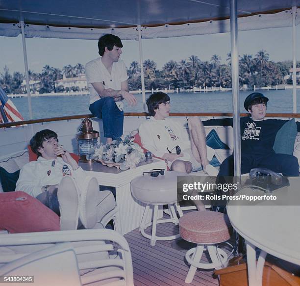 Ringo Starr, Paul McCartney, George Harrison and John Lennon of The Beatles relax on a houseboat off Miami harbour in the United States in February...