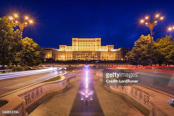 palace of parliament at night - bucharest stock pictures, royalty-free photos & images