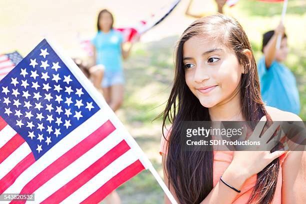 cute preteen hispanic girl with american flag at parade - child beauty pageant stock pictures, royalty-free photos & images