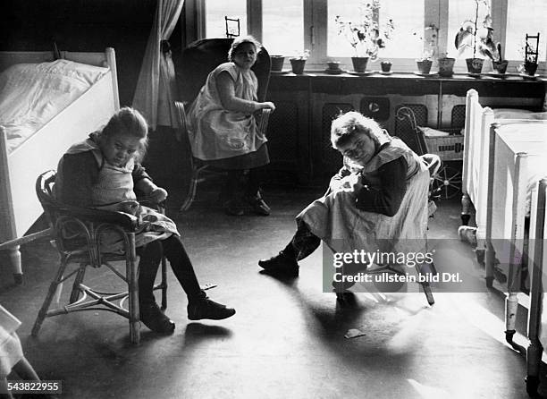 Mentally ill girls sitting in their room, probably in the Mental hospital in Ursberg, Swabia- Photographer: Wolfgang Weber- published by Berliner...