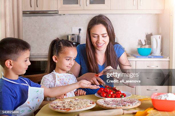 family making pizza together - baby chef stock pictures, royalty-free photos & images