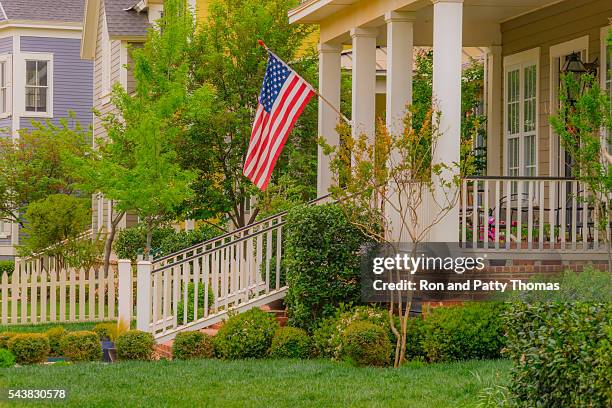 old fashioned home town street with american flag (p) - lubbock texas stock pictures, royalty-free photos & images