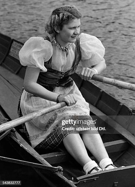Young woman wearing a Dirndl in a rowboat - Photographer: Lothar Ruebelt- Published by: 'Erika' 26/1940Vintage property of ullstein bild