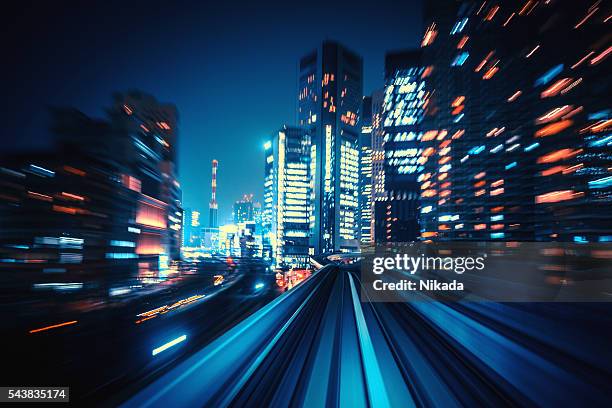 abstract motion-blurred view from a moving train - city night speed stock pictures, royalty-free photos & images